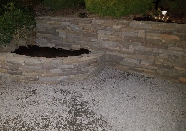 Curved stacked stone planter and retaining wall