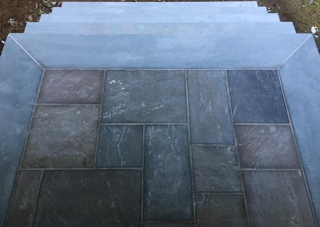 Bluestone steps with a pattern stone landing framed in thermal bluestone