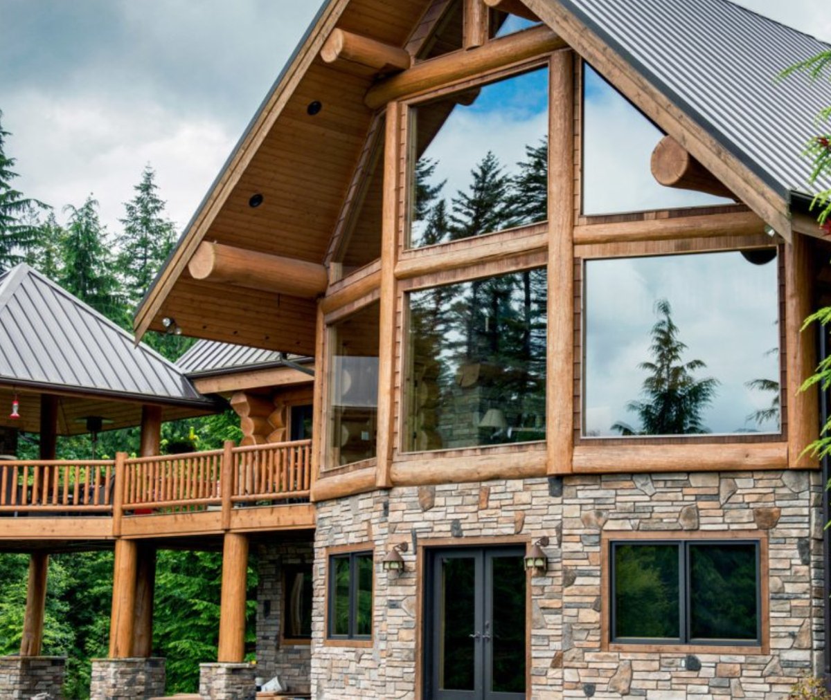 Log home with a Cultured Stone ledgestone lower level and column bases