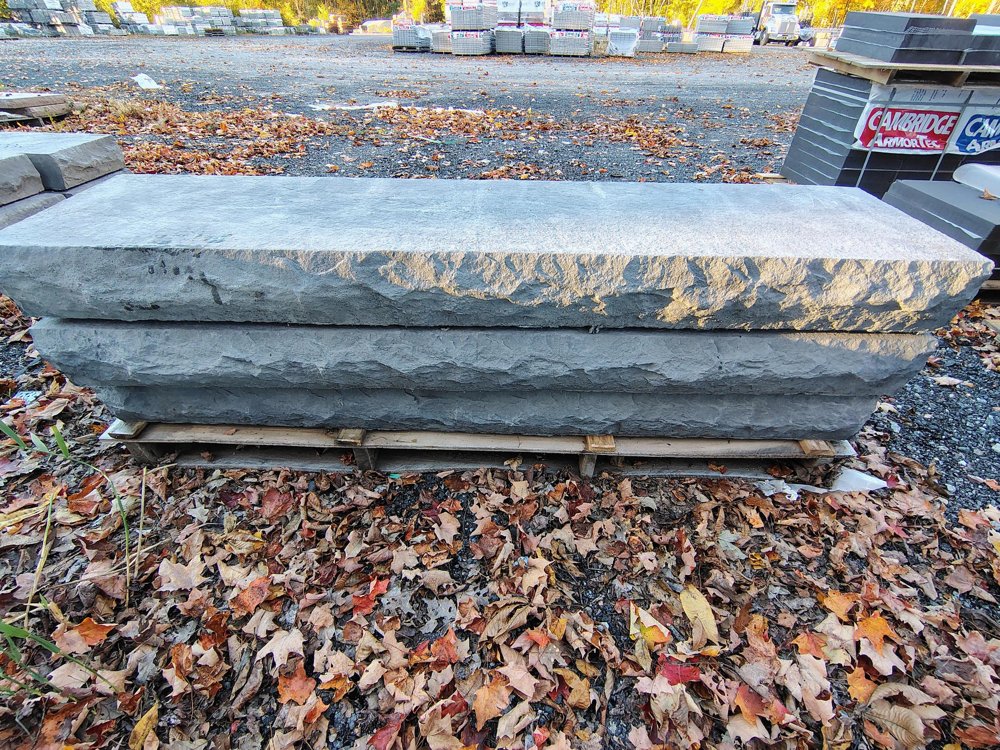 Cambridge 72 inch cast stone steps in Bluestone stacked on a pallet in the yard