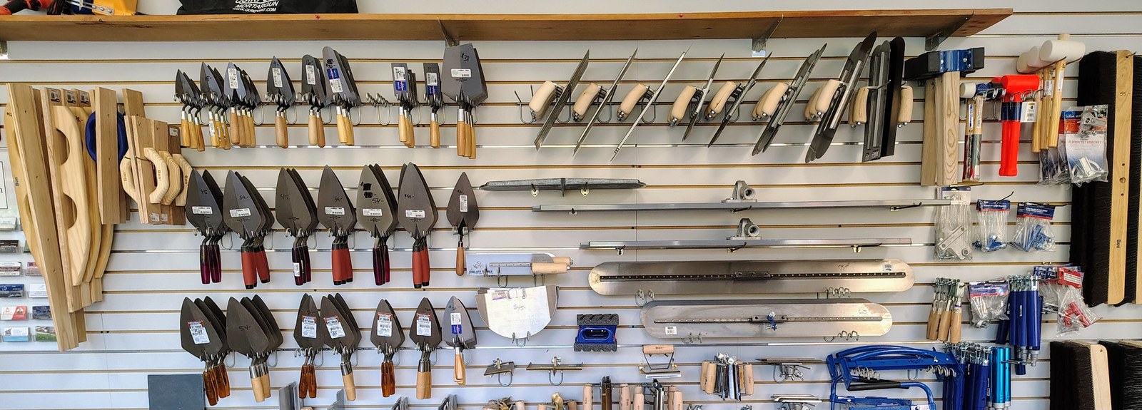 Showroom wall of trowels and floats