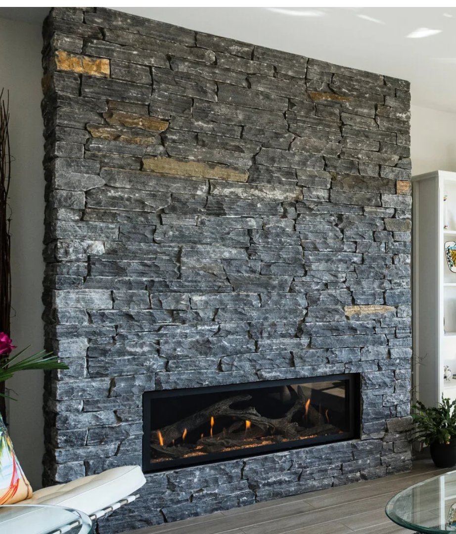 Pangaea ledgestone fireplace wall with a linear gas fireplace