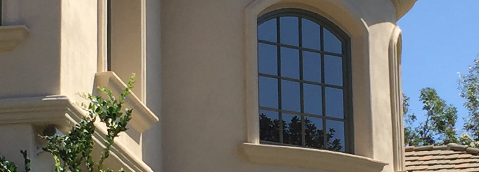 Stucco home exterior with a curved turret
