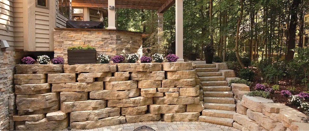Rosetta Outcropping boulder-style retaining wall with matching steps beside a covered deck