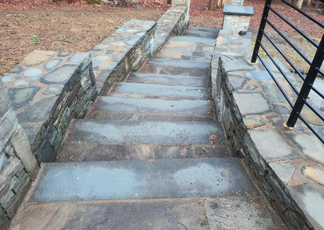 Bluestone steps between stone walls with flagstone caps