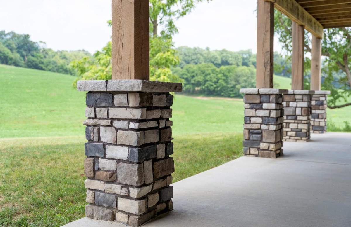 ProVia stone porch column bases with stone caps beneath timber posts