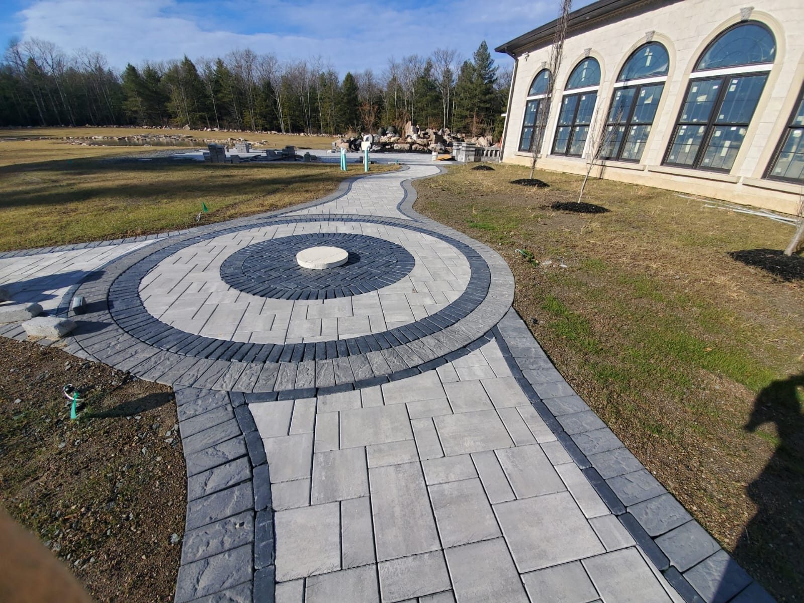 Circular paver plaza and walkway beside a building