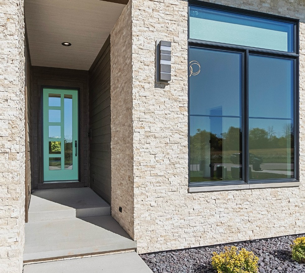 Modern home entry and exterior walls in light stacked stone veneer