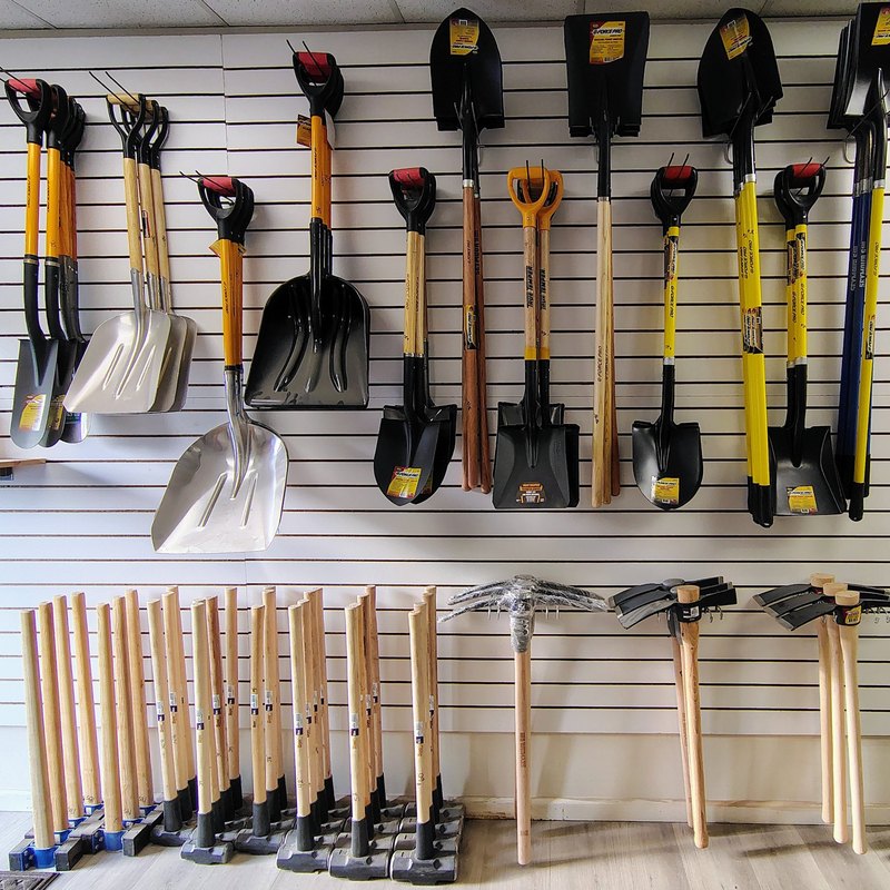 Shovels, picks and sledge hammers on the showroom wall