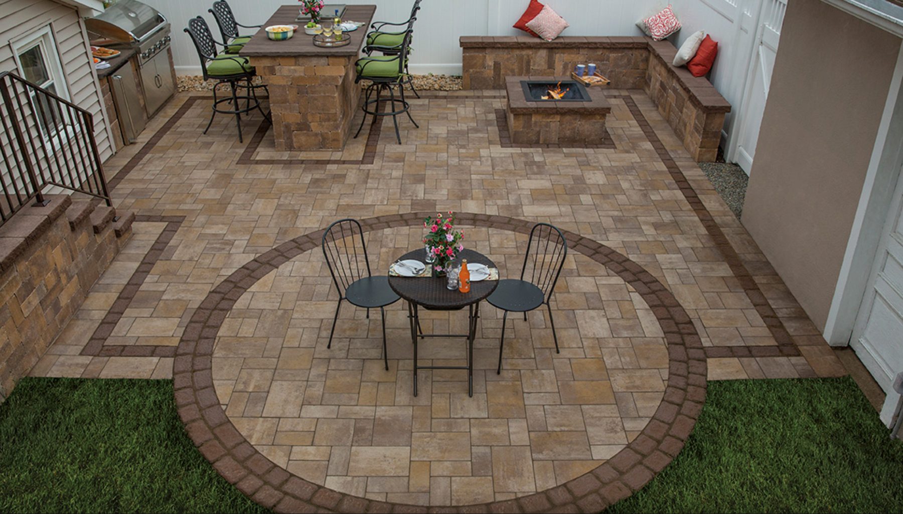 Outdoor bar with seating next to a dining area and fire pit