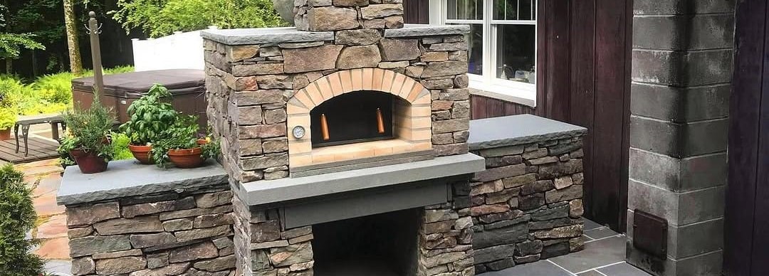 Stone outdoor pizza oven with bluestone counters