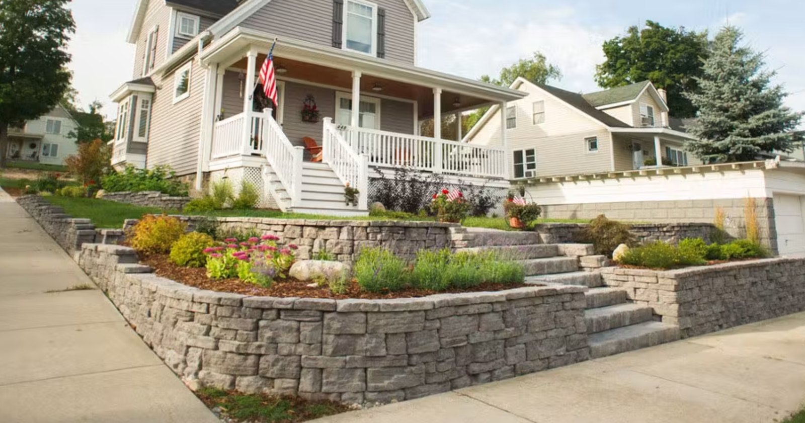 Terraced Rosetta retaining walls with natural stone-look steps leading up to a front porch