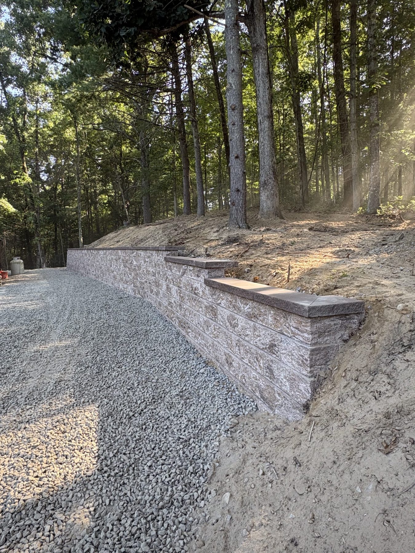 Retaining wall with steps along a gravel driveway