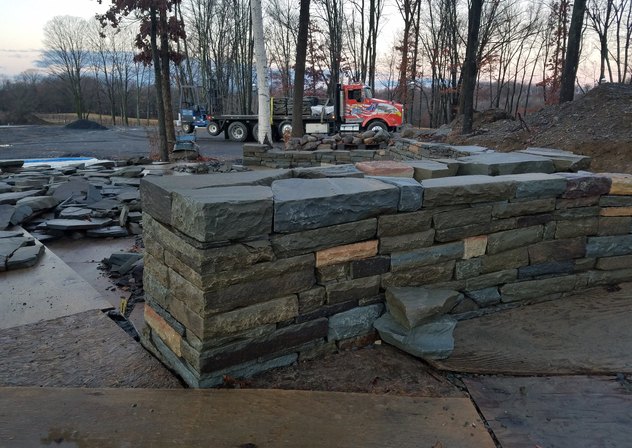 Dry-stacked bluestone wall with heavy natural caps