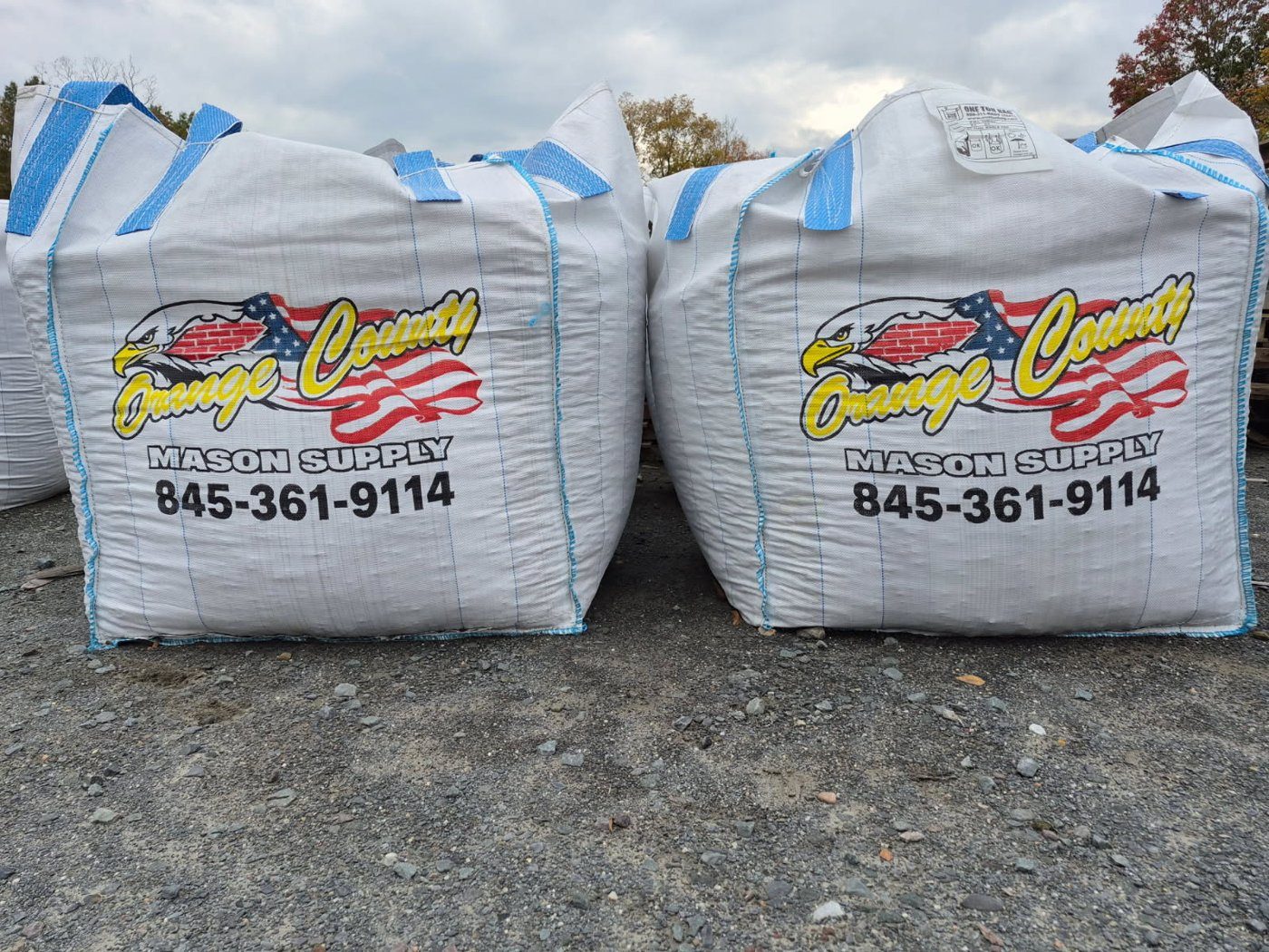 Two 1-yard super sacks of bulk material in the yard