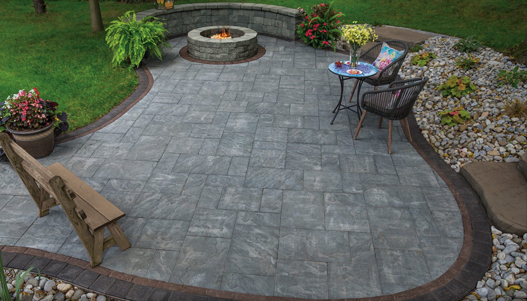 Cambridge fire pit built into a curved seat wall
