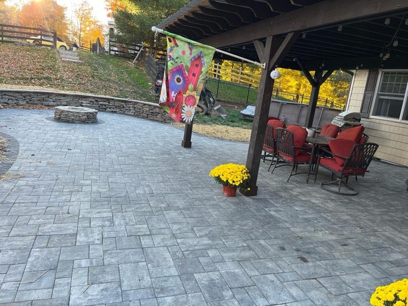 Covered paver patio with outdoor seating