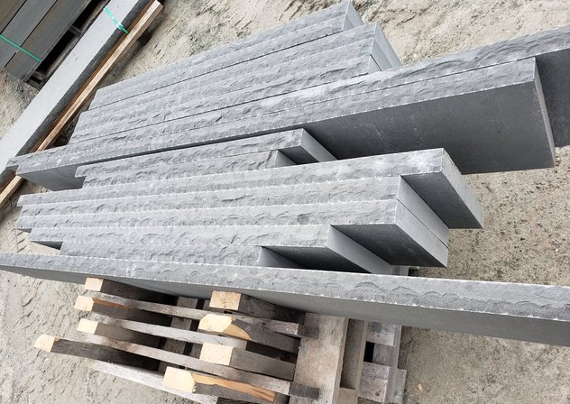 Rock face bluestone treads on a pallet at the yard