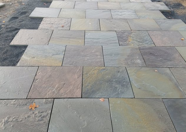 Full color bluestone pattern walkway being laid