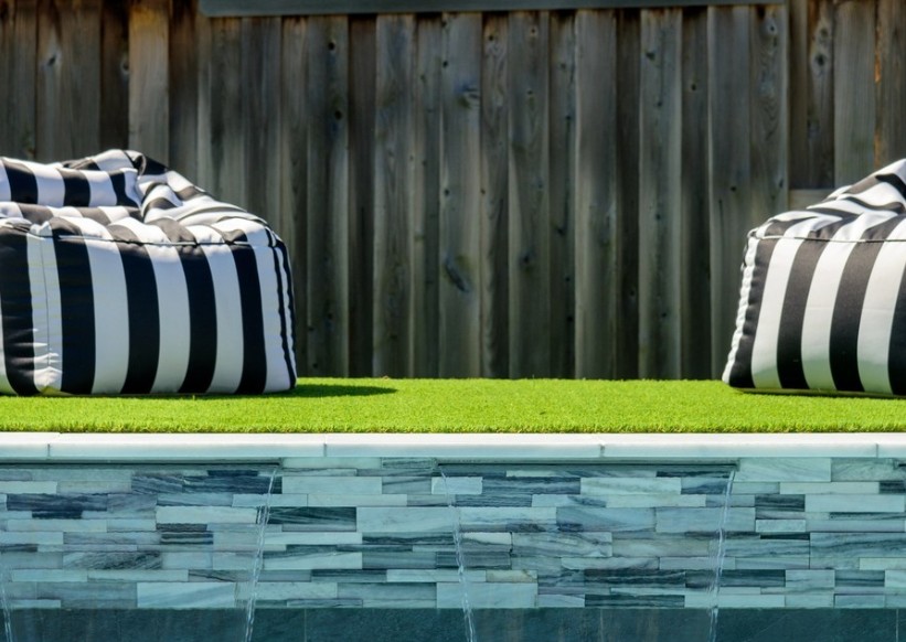 Pool water feature wall faced in stacked stone